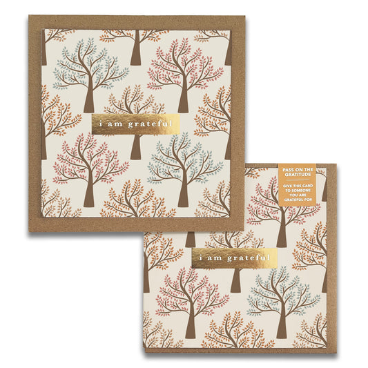 The Walk in the Park Gratitude Greeting Card by Maylay Co. features an autumn tree pattern in pastel hues with "I am grateful" prominently displayed at the center. Ideal as a Gratitude Card, its design adorns both sides, inspiring you to share your appreciation with someone special.