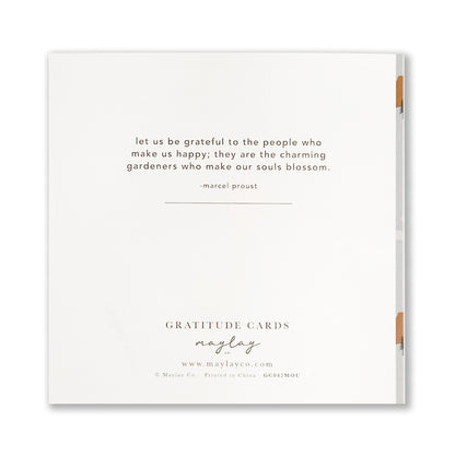 A square greeting card features a quote by Marcel Proust: "Let us be grateful to the people who make us happy; they are the charming gardeners who make our souls blossom." Below the quote, it reads "THANK YOU" alongside Mountains Gratitude Greeting Cards by Maylay Co.